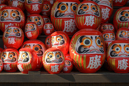 Stack of many red daruma dolls on wooden shelf in Katsuo-ji temple, Minoh, Osaka, Japan. The Kanji translated to English : "Victory"の写真素材