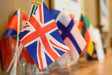 A small British or UNITED KINGDOM National Flag stands among various flags with copy spaceの写真素材