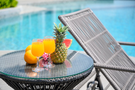 Refreshing tropical drinks and fruits by the poolside, perfect for summer vacation and relaxation