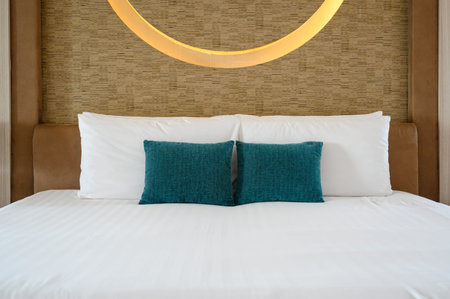 decoration interior of bedroom at home or hotel. Empty comfortable bed with white blanket and...