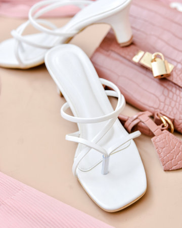 Women's shoes and accessories on a beige background. Selective focusの写真素材