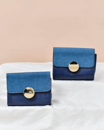 Blue leather clutch on a beige background. Fashionable concept.の写真素材