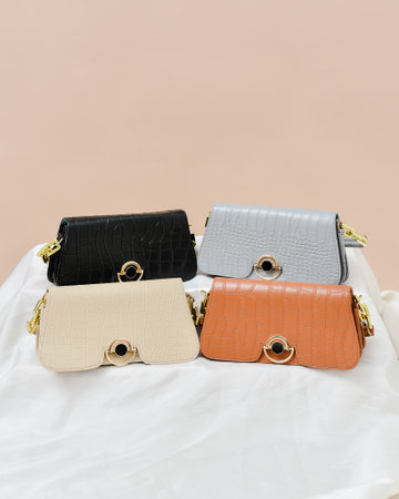 Women's leather handbags on a beige background. View from above.の写真素材