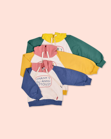 Colorful t-shirts isolated on a pastel pink background.の写真素材