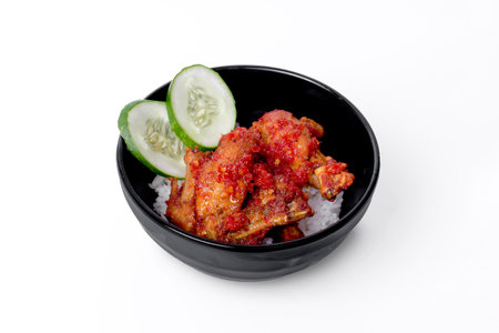 Fried chicken with rice in black bowl isolated on white background.の写真素材