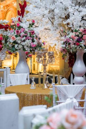 Wedding table decorated with flowers and candles in a restaurant.のeditorial素材