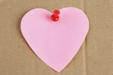 heart shaped post-it on brown cardboard