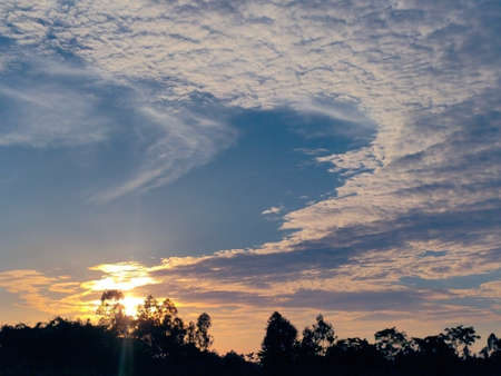 Beautiful cloudy sky with sunlight and trees.の写真素材