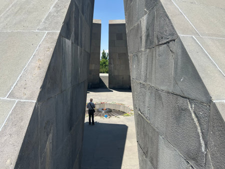 Man standing in Tsitsernakaberd Monument to commemorate the victims of the Genocide in Yerevan in Armeniaのeditorial素材