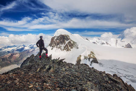 Breithorn Mounitan in Swiss alps. Tourist standing on Klein Matterhorn looking at Breithorn. Outdoor and adventure photography.の写真素材