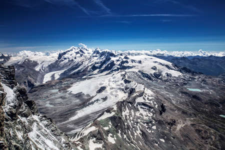 Alpine beautiful landscape. Panoramic view on Alps peaks and glacier. Beautiful blue sky.の写真素材