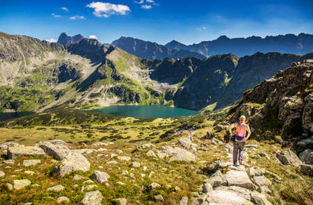 Tourist and hiker on trail in high mountains .  Activity in alpine style scenery. High mountain lanscape in  Europe. Tatras in summer.の写真素材