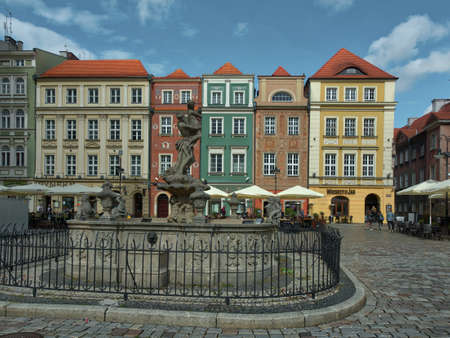 Fountain and tenement houses. Proserpina Fountain in front of the entrance to the Town Hall in the...