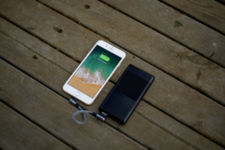 mobile phone charging black powerbankの写真素材