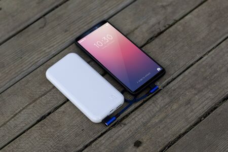 mobile phone charging white powerbankの写真素材