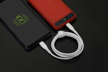 mobile phone charging red powerbank