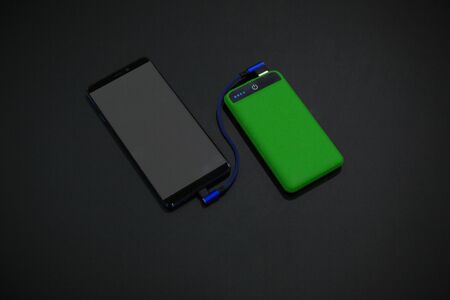 mobile phone charging green powerbankの写真素材
