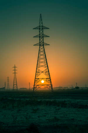 Sunsrise in Iraqi desert where the huge power line towersの写真素材