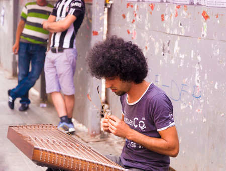 Istanbul, Turkey - May 13, 2015:Young musician in street with traditional eastern instrument plying...