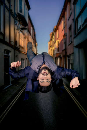 Levitation scene of boy inside narrow alley at nightの写真素材