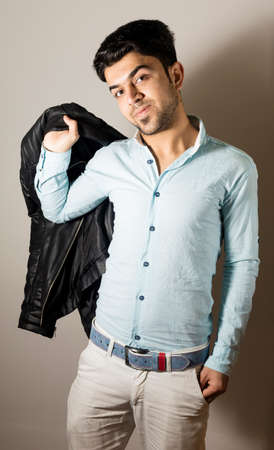 Brunette boy Isolated inside Studio with black jacketの写真素材