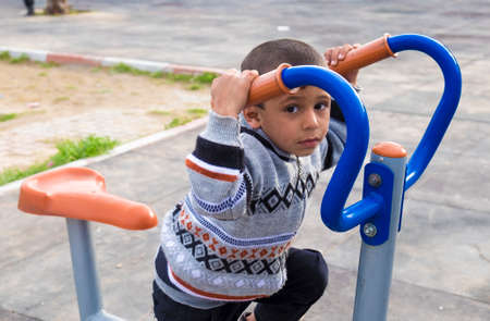 Kirkuk, Iraq - February 1, 2016: Orphan syrian child inside park in Kurdistan region in Erbil