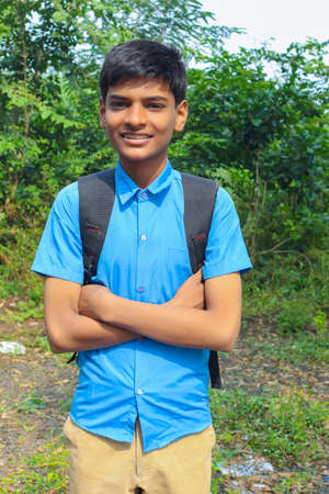 Clever schoolboy raising his trophy as a winner in school competition.の写真素材