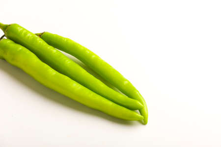 Fresh Green chilli and tomatos on white background.の写真素材