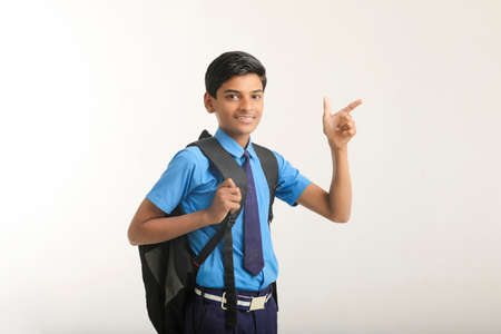 Indian school boy standing on white background.の写真素材