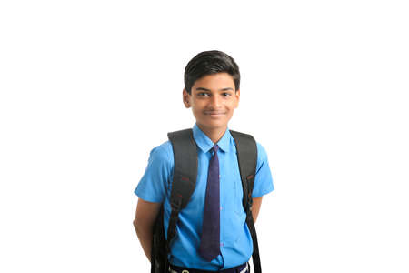 Indian school boy standing on white background.の写真素材