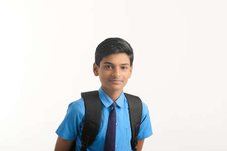 Indian school boy standing on white background.の写真素材