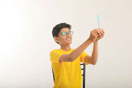 young indian child showing a pen, marker