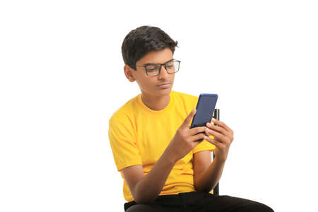 Cute Indian child using smartphone. online education concept
