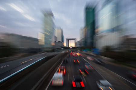Cars moving towards skyscrapers in big cityの写真素材