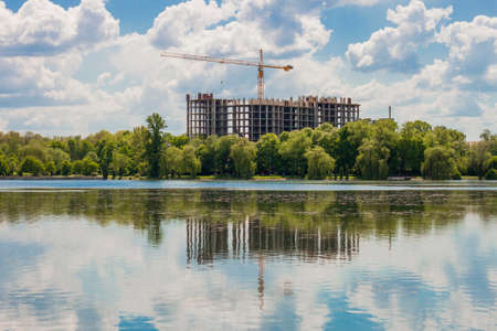 Building under construction on the bank of  lakeの写真素材