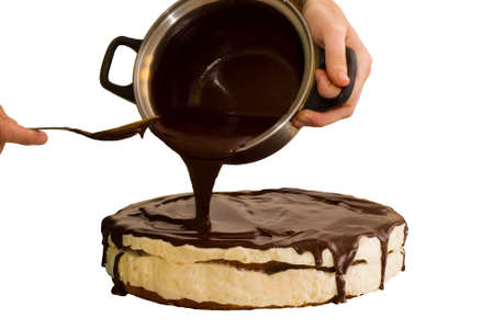 Chocolate flowing on the Cake isolated on whiteの写真素材