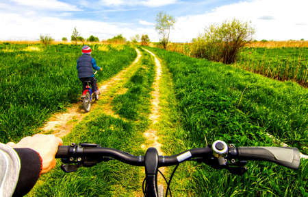 Boy on bike on country road sunny spring dayの写真素材
