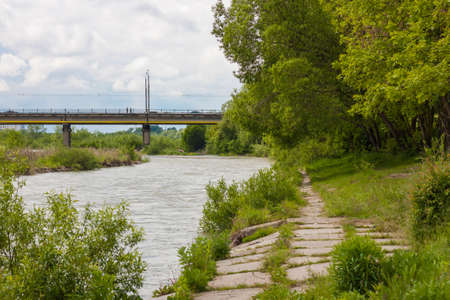 River in sunny day green trees and bridge viewの写真素材