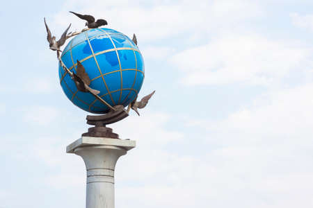 Earth globe with doves around itの写真素材