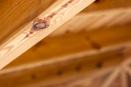 Yellow wooden element from roof structure closeupの写真素材