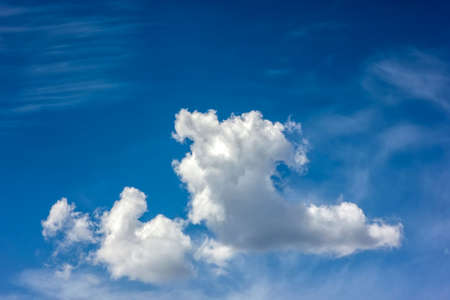 Blue sky with puffy white clouds in bright clear sunny dayの写真素材