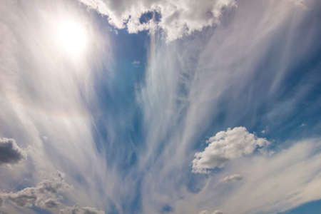 Dramatic blue sky with puffy white clouds in bright clear sunny dayの写真素材
