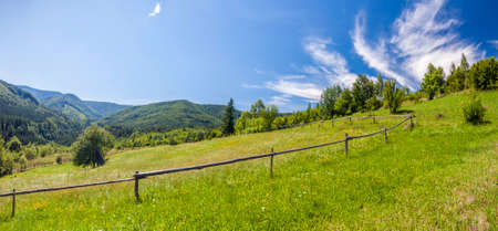 Sharp green mountain peaks and sky with dramatic clouds landscapeのeditorial素材