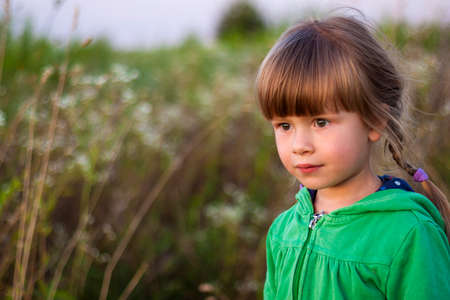 Cute little girl looking seriously aheadの写真素材