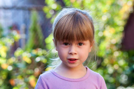 Portrait of little girl with surprised expression on face