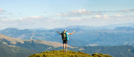 Hiker standing on top of mountain. Unity with nature concept.の写真素材