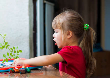 Little cute girl playing table play outside