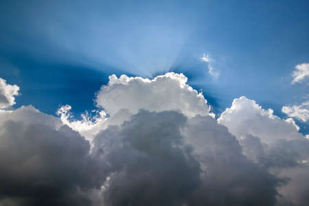 Blue sky with puffy white clouds in bright clear sunny dayの写真素材