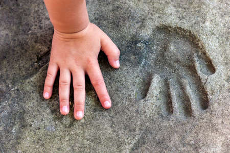 Childs hand and memorable handprint in  concreteの写真素材