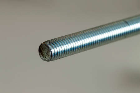 Stainless steel bolts and nuts on a white background. Bolt, washer and nut on a white background. Bolt on a white background. Bolt screw nut washer carving.の写真素材